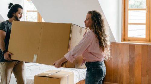 woman carrying packed boxes