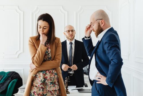 angry couple in front of lawyer