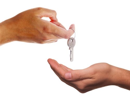 one spouse handing the keys to the other to follow property division terms