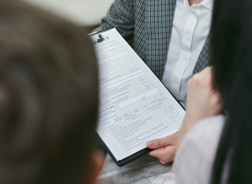 woman holding clipboard with forms