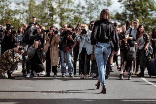 paparazzi taking photo of woman