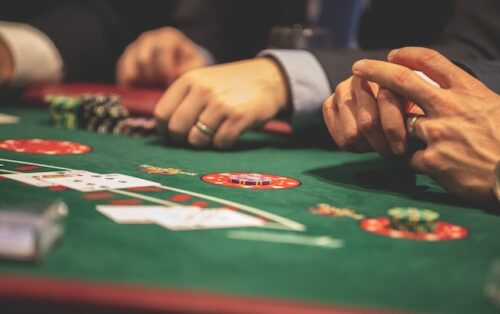 person at table playing poker