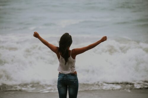 woman standing in front of ocean