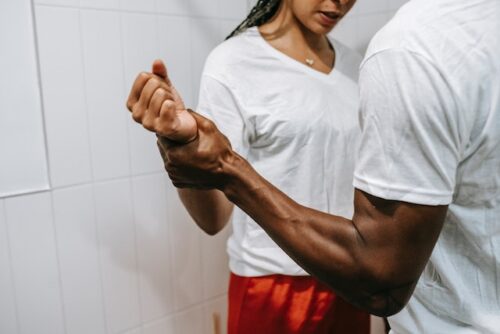 man holding woman's wrist