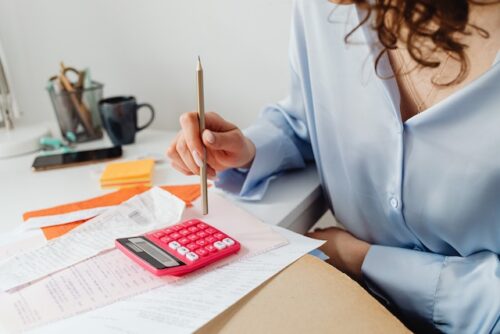 woman at desk calculating