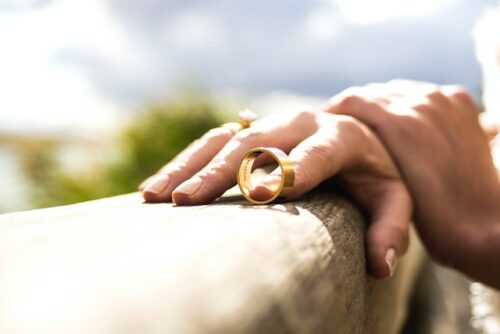 woman holding man's wedding band