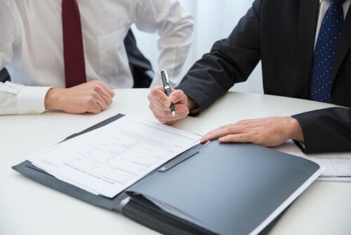 two people sitting in front of document