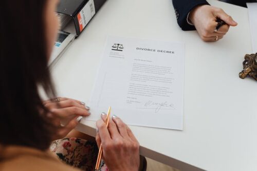 woman with divorce decree on table