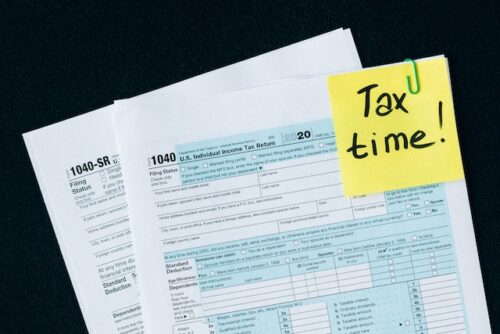 tax form with "tax time" on post it note