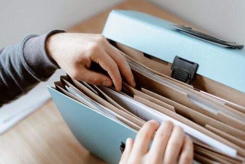 person looking through a file folder