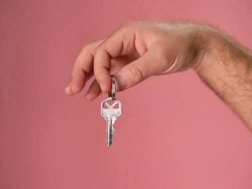 person holding key