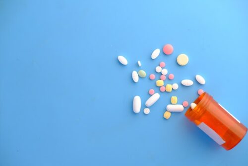 pill bottle on blue background