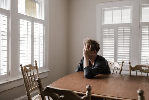 sad man sitting at table